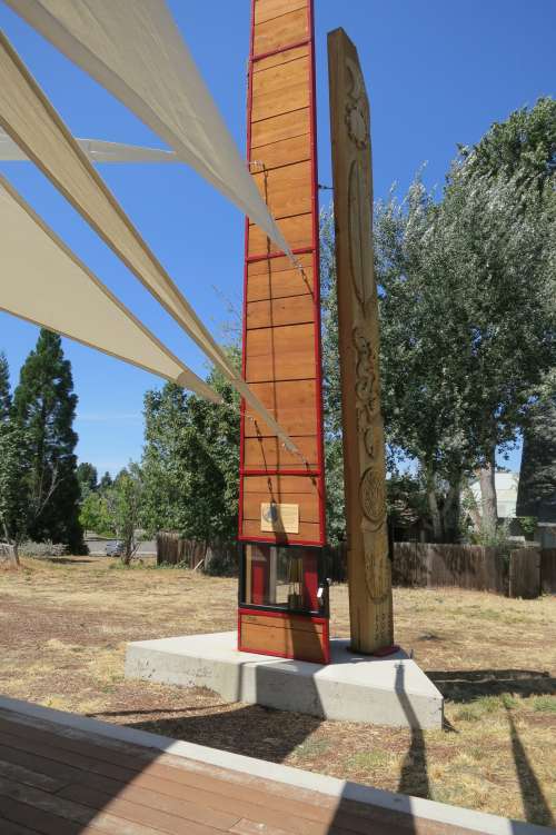 Eternal Peace Flame flanked by Anishinabe Teaching Poles